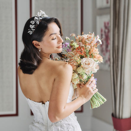 Bride wearing Pearl tiara holding bouquet